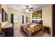 Bedroom with queen bed, wood dresser, and window shutters at 5640 E Miramonte Dr, Cave Creek, AZ 85331