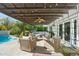 Poolside patio furniture under a pergola with a view of the pool at 6836 N 1St Pl, Phoenix, AZ 85012