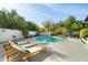 Inviting pool with wooden loungers and a table at 6836 N 1St Pl, Phoenix, AZ 85012