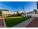 Artificial turf backyard with pergola, seating, and walkway at 726 E Amelia Ave, Phoenix, AZ 85014