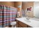 Guest bathroom with shower/tub combo and wood vanity at 7979 E Evening Glow Dr, Scottsdale, AZ 85266