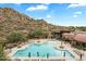 Resort-style pool with expansive deck and mountain views at 7979 E Evening Glow Dr, Scottsdale, AZ 85266