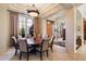 Elegant dining room with large table and seating for eight, featuring large windows and high ceilings at 7979 E Evening Glow Dr, Scottsdale, AZ 85266