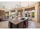 Open kitchen with island, stainless steel appliances, and views of backyard at 7979 E Evening Glow Dr, Scottsdale, AZ 85266