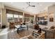 Spacious living room with comfortable seating, a stone fireplace, and large windows at 7979 E Evening Glow Dr, Scottsdale, AZ 85266