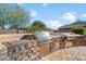 Upscale outdoor kitchen with stainless steel appliances and stone counters at 7979 E Evening Glow Dr, Scottsdale, AZ 85266