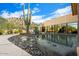Desert landscape with a reflecting pool, cactus, and pathway at 7979 E Evening Glow Dr, Scottsdale, AZ 85266