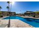 Inviting community pool with surrounding patio furniture at 8055 E Thomas Rd # D115, Scottsdale, AZ 85251