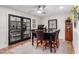 Dining area with dark wood table, six chairs and access to the patio at 8537 E Montecito Ave, Scottsdale, AZ 85251