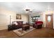 Bright living room with leather furniture and large window at 9843 W Cedar Dr, Sun City, AZ 85351