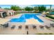 Refreshing community pool with lounge chairs and umbrellas at 14539 W Sheridan St, Goodyear, AZ 85395