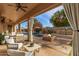 Spacious covered patio features comfortable seating and pool views at 14539 W Sheridan St, Goodyear, AZ 85395
