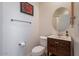 Clean bathroom with a toilet, sink, and oval mirror, simple and functional at 14850 E Grandview Dr # 242, Fountain Hills, AZ 85268