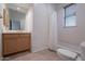 Bathroom with a wooden cabinet, toilet, and bathtub at 14850 E Grandview Dr # 242, Fountain Hills, AZ 85268