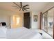 King bedroom with balcony access and a large TV at 14850 E Grandview Dr # 242, Fountain Hills, AZ 85268
