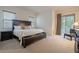 Primary bedroom with king-size bed, nightstands, and access to a balcony at 14850 E Grandview Dr # 242, Fountain Hills, AZ 85268