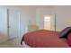 Simple bedroom with a dresser, bed, and access to another room at 14850 E Grandview Dr # 242, Fountain Hills, AZ 85268