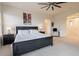 Bright bedroom with king-size bed, ceiling fan, and access to other rooms at 14850 E Grandview Dr # 242, Fountain Hills, AZ 85268