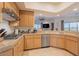 Modern kitchen with granite counters, stainless steel appliances, and light wood cabinets at 14850 E Grandview Dr # 242, Fountain Hills, AZ 85268