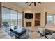 Spacious living room with fireplace, built-in shelving, and access to balcony at 14850 E Grandview Dr # 242, Fountain Hills, AZ 85268