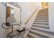 Elegant carpeted staircase with ornate iron railings and lighting at 14850 E Grandview Dr # 242, Fountain Hills, AZ 85268
