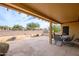 Covered patio with flagstone flooring, seating area, and built-in grill at 15608 W Vista Grande Ln, Surprise, AZ 85374