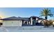 Front view of a house with a light-green garage door and palm trees at 17020 N 125Th Ave, Sun City West, AZ 85375