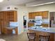 Kitchen with island, wood cabinets and a view into the living room at 17020 N 125Th Ave, Sun City West, AZ 85375