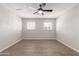 Bright bedroom featuring wood-look floors and a ceiling fan at 1718 S Marilyn Ann Dr, Tempe, AZ 85281