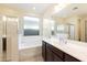 Bathroom featuring a soaking tub and shower at 18224 W Carlota Ln, Surprise, AZ 85387