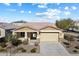 Single-story home with two-car garage and landscaped yard at 18224 W Carlota Ln, Surprise, AZ 85387