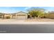 Single-story home with two-car garage and desert landscaping at 18749 N Siltstone Ln, Surprise, AZ 85387