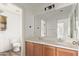 Bathroom with double vanity, mirror, and toilet at 19668 E Carriage Way, Queen Creek, AZ 85142