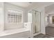 Bathroom features a soaking tub, shower, and a window at 19668 E Carriage Way, Queen Creek, AZ 85142