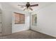 Well-lit bedroom with ceiling fan and carpet flooring at 19668 E Carriage Way, Queen Creek, AZ 85142