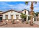 Two-story house with stucco exterior, tile roof, and desert landscaping at 19668 E Carriage Way, Queen Creek, AZ 85142
