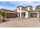 Two-story house with tile roof, two-car garage, and desert landscaping at 19668 E Carriage Way, Queen Creek, AZ 85142