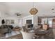 Open living and dining area with hardwood floors and modern lighting at 19668 E Carriage Way, Queen Creek, AZ 85142