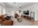 Spacious living room with leather furniture and large windows at 21171 E Stirrup St, Queen Creek, AZ 85142