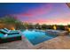 Luxury backyard oasis featuring a rectangular pool, hot tub, and lounge chairs at 22023 N 34Th Way, Phoenix, AZ 85050