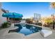 Inviting backyard pool with basketball hoop and blue umbrella at 22851 S 204Th St, Queen Creek, AZ 85142