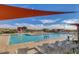 Relaxing pool area with lounge chairs and shade structure at 23075 E Stonecrest Dr, Queen Creek, AZ 85142