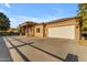 Attached garage with a white door and long driveway at 23323 S 199Th Pl, Queen Creek, AZ 85142