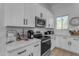 Modern kitchen with white cabinets, stainless steel appliances, and marble countertops at 23323 S 199Th Pl, Queen Creek, AZ 85142