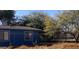 Side view of a blue house with a chain link fence at 300 5Th E Ave, Buckeye, AZ 85326