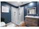 Modern bathroom with a glass shower and blue walls at 3224 E Desert Cove Ave, Phoenix, AZ 85028