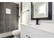 Updated bathroom with dark tile, white vanity, and modern fixtures at 331 E Pierce St, Tempe, AZ 85288