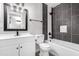Clean bathroom with white vanity, dark tile, and bathtub at 331 E Pierce St, Tempe, AZ 85288