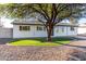 Single-story home with a tree-lined yard and a gray driveway at 331 E Pierce St, Tempe, AZ 85288