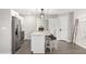 Modern kitchen with white cabinets, a kitchen island, and stainless steel appliances at 331 E Pierce St, Tempe, AZ 85288